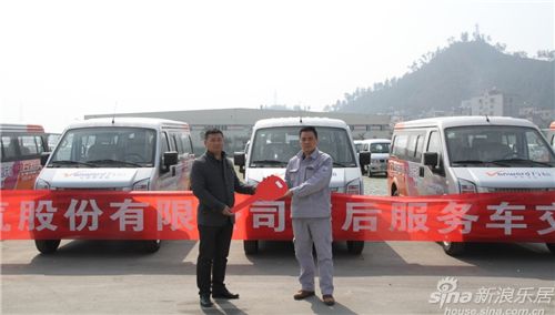 東風小康汽車有限公司相關負責人向萬和公司代表(左)交車